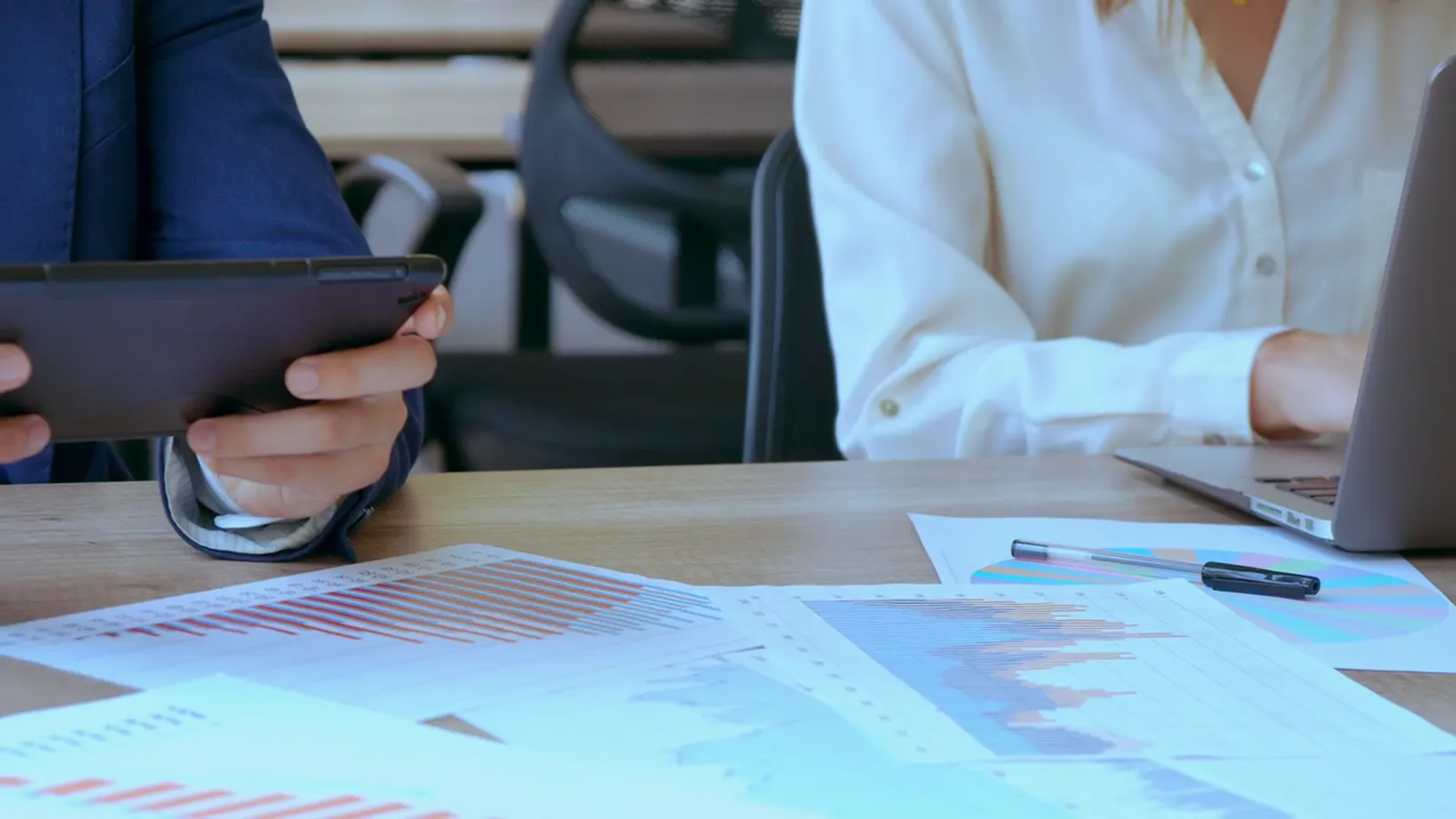 Financial reports spread out on a meeting table