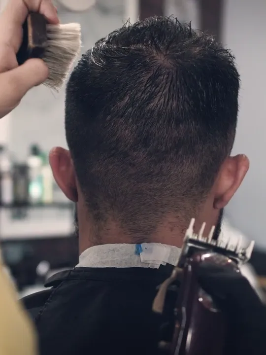 A textured crop being cut with clippers