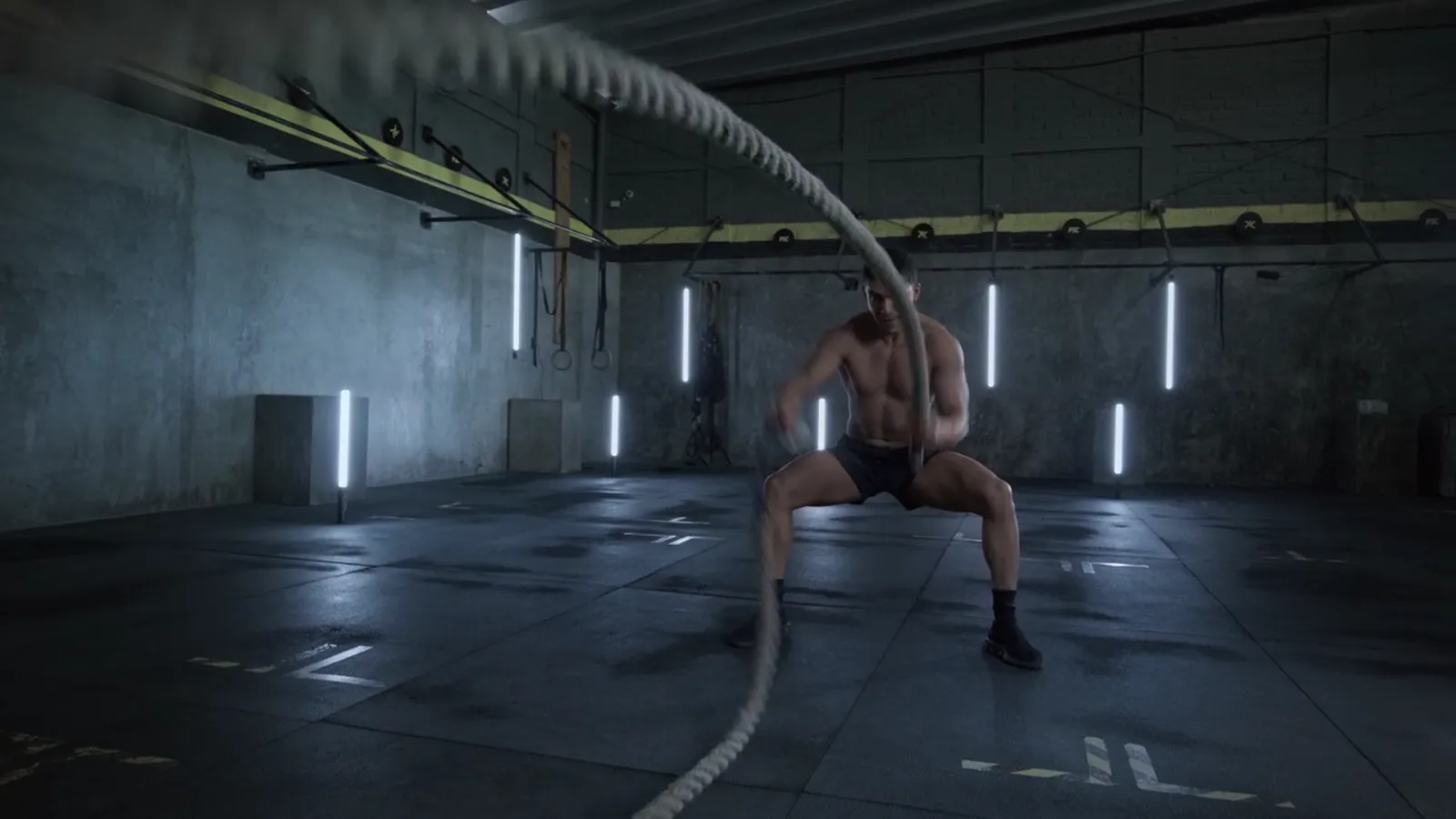 A man swinging battle ropes