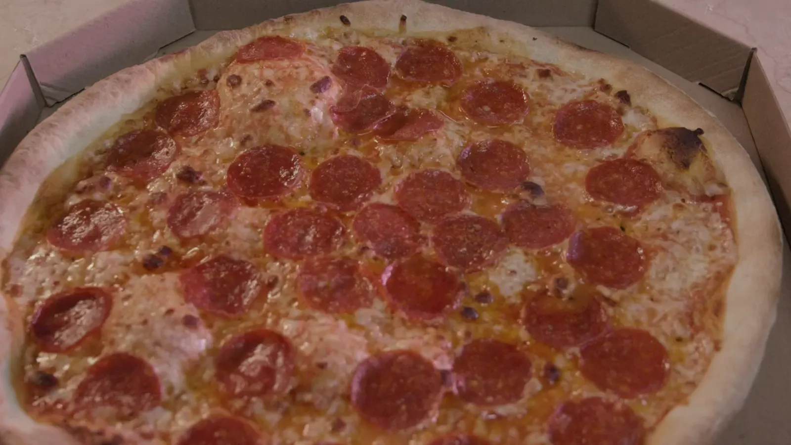Pepperoni pizza in a takeout box