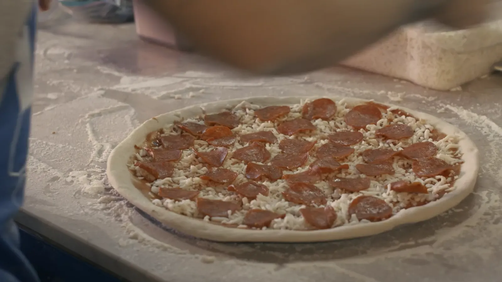 Unbaked pepperoni pizza ready for the oven