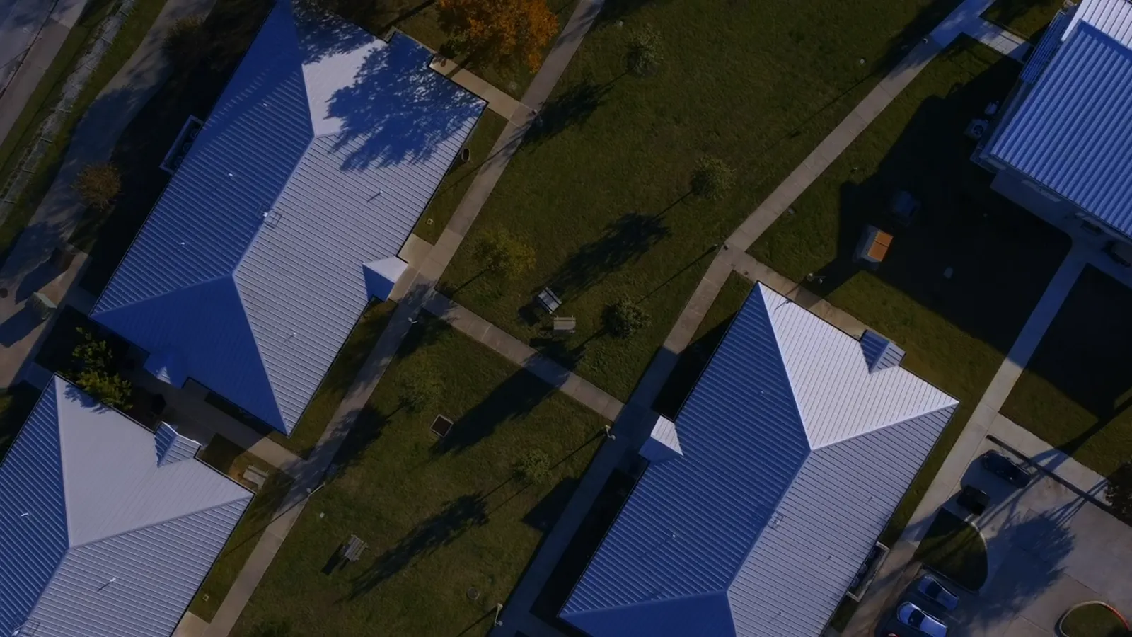 Aerial view of houses with blue standing-seam metal roofs