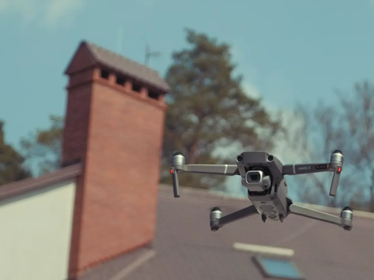 The inspection drone hovering beside the chimney